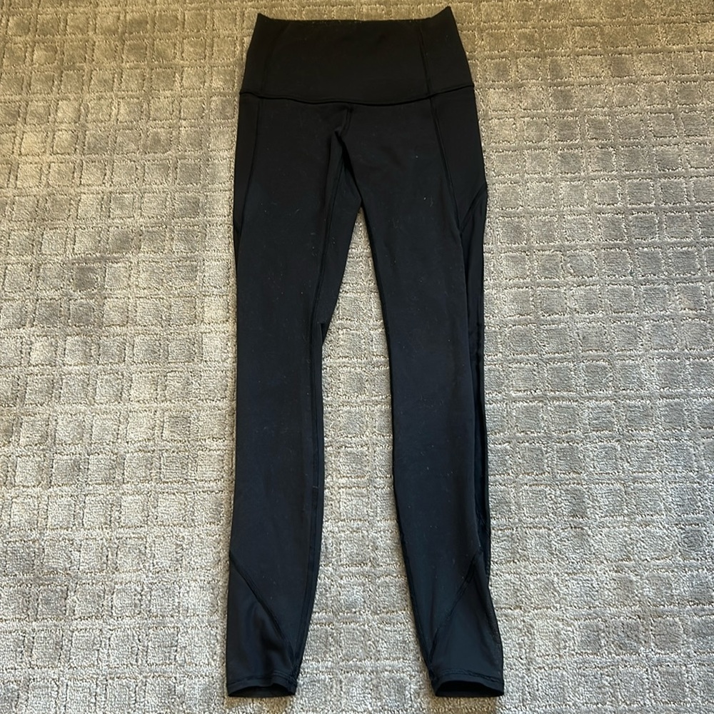 Black Lululemon leggings with lace on the side. Back and side pockets